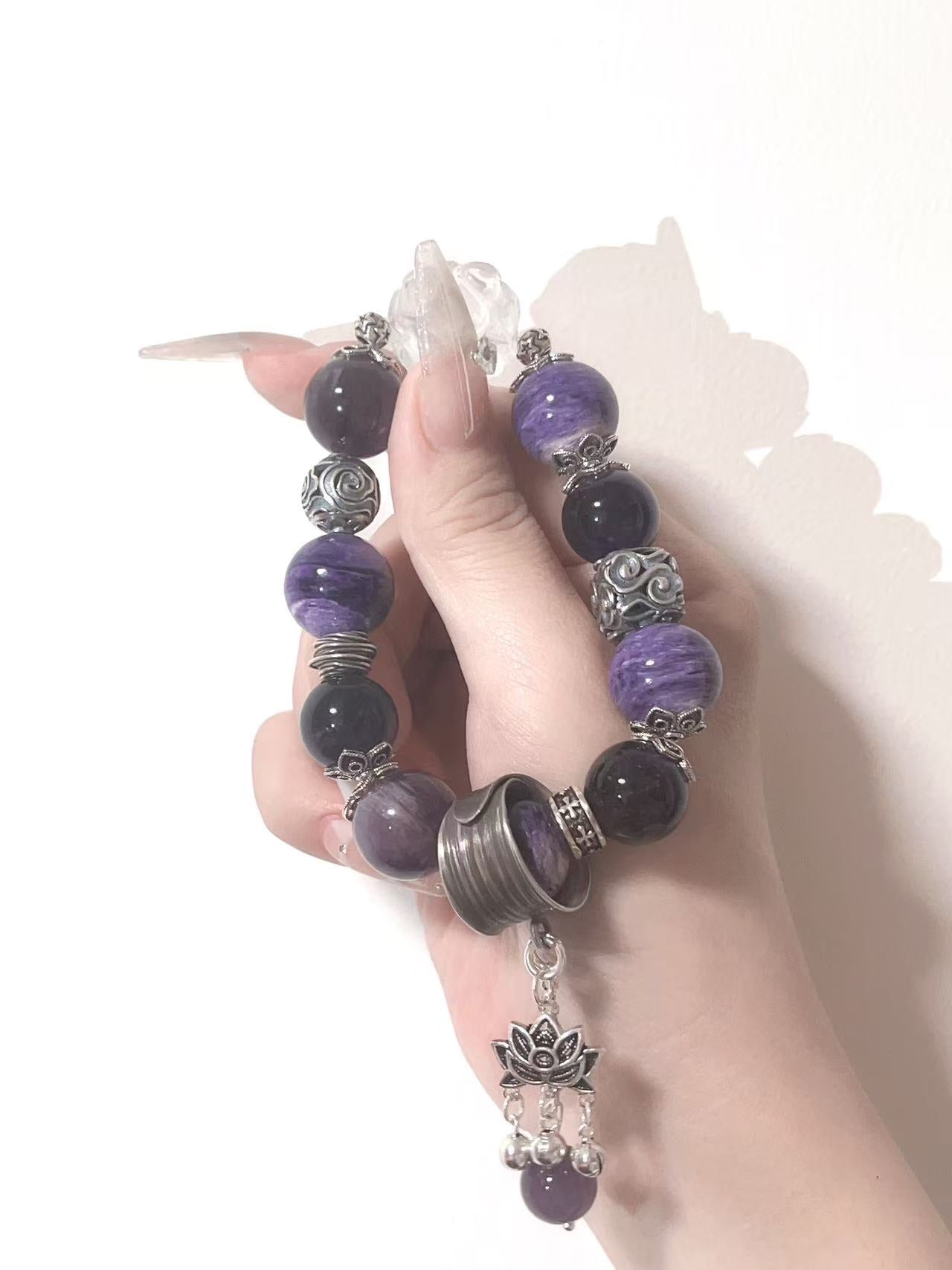 Purple and black crystal bracelet with lotus charm
