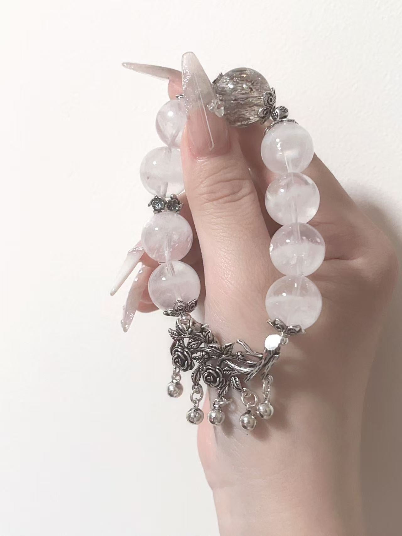 White crystal bracelet with silver floral charm for Metal styling reference