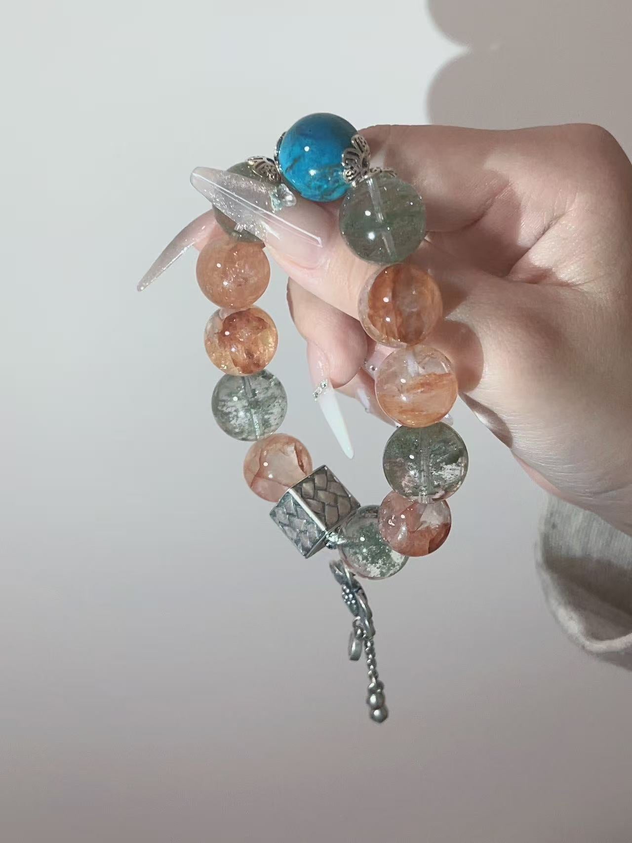 Blue green and orange crystal bracelet with geometric charm