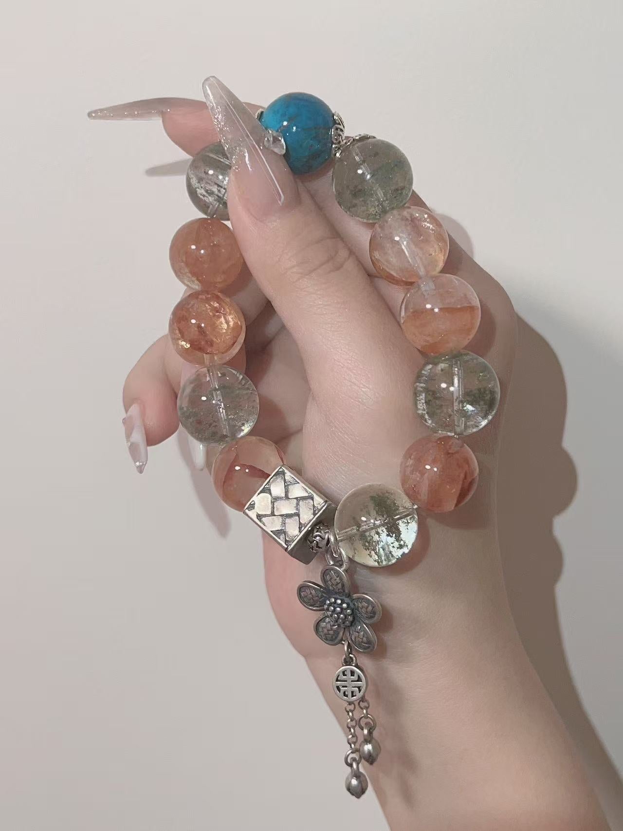 Finished crystal bracelet with warm bead and charm details