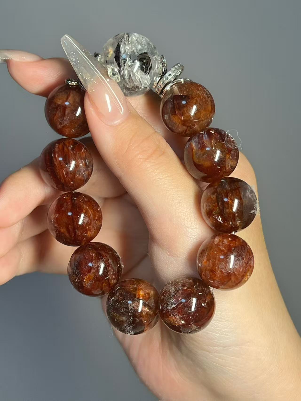 Crystal bracelet with pale stones and gold charm detail
